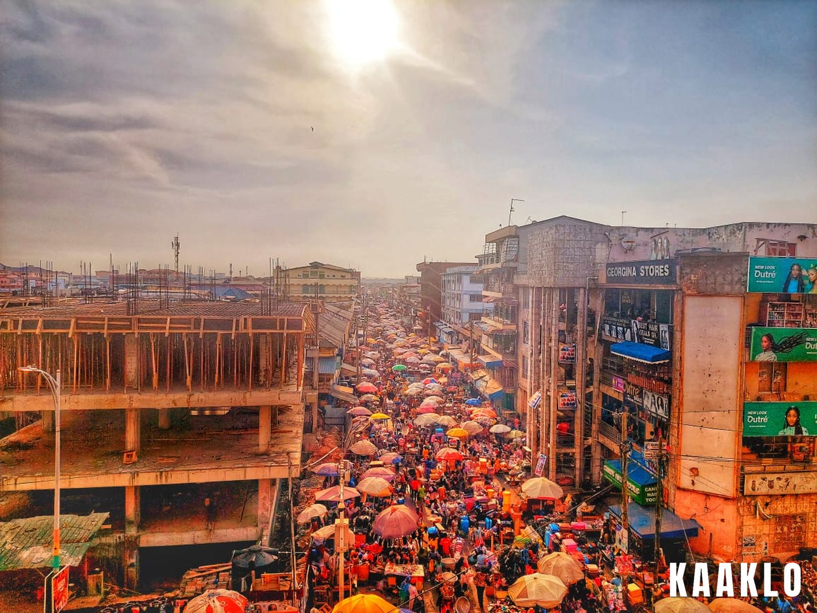 A busy trading day at Makola Market in Accra with shoppers and vendors.