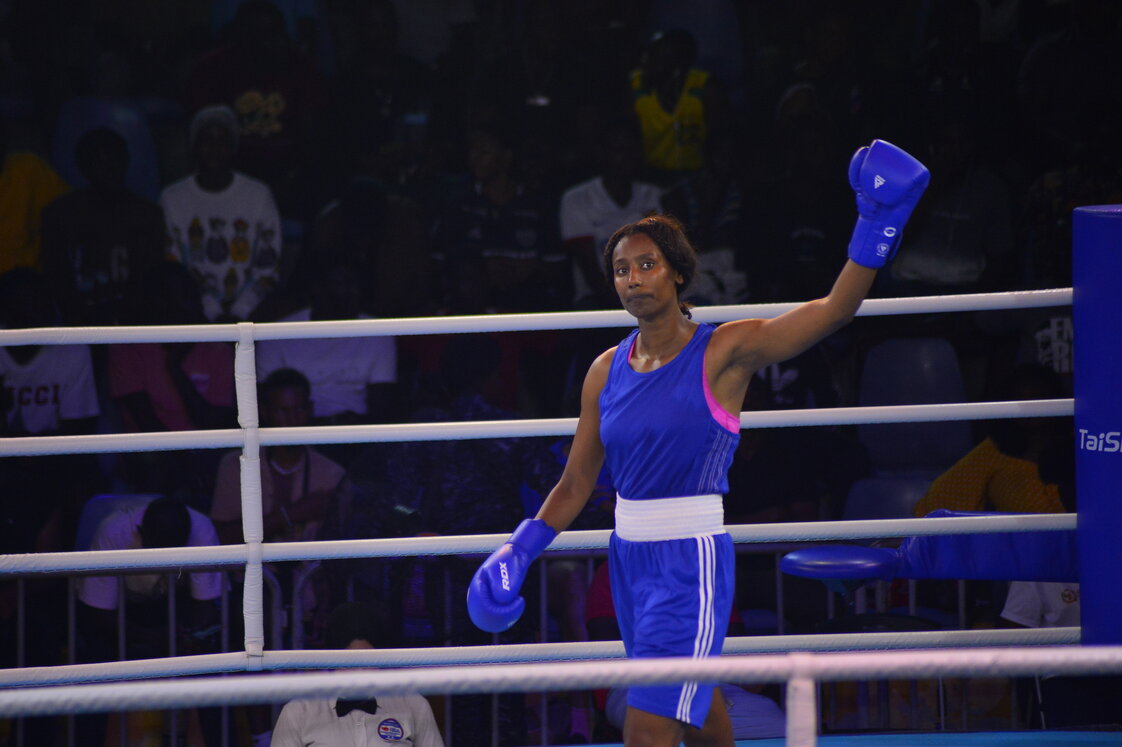 A boxer raises her glove in celebration in the ring at the 2023 African Games in Accra.