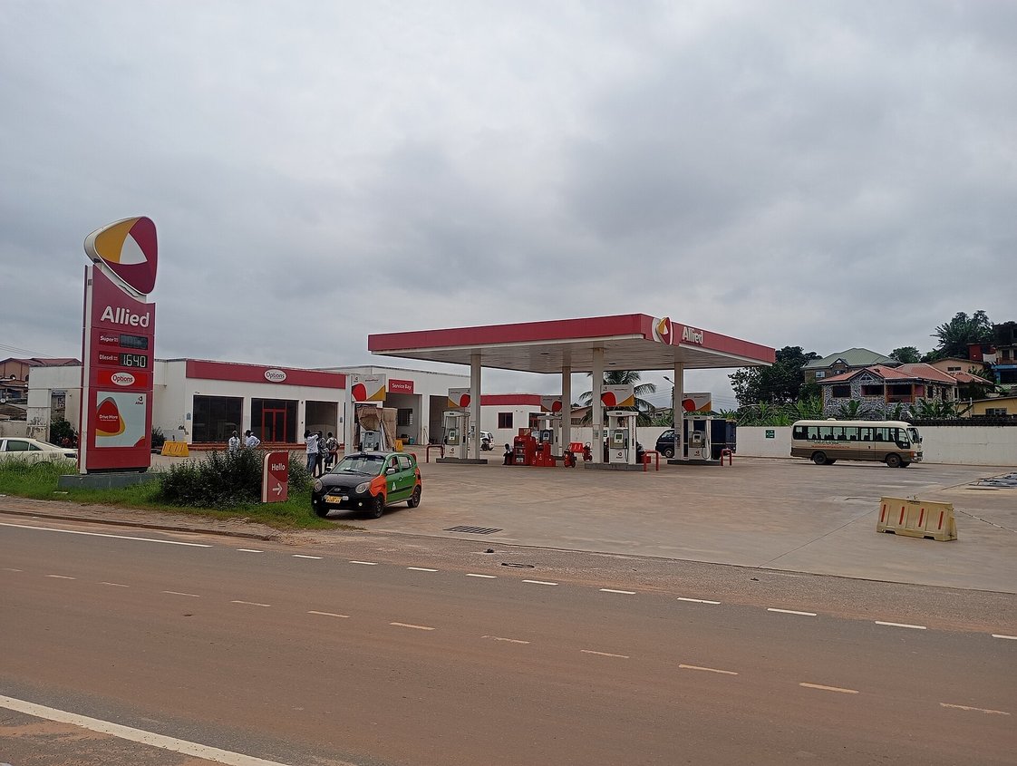 An Allied filling station in Ghana, with pumps under a canopy and a price board by the road.